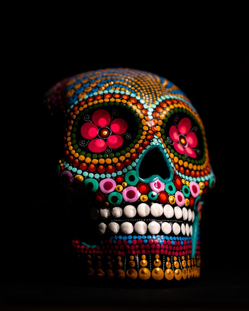 A vibrant and colorful sugar skull depicting Day of the Dead art with intricate designs on black background.